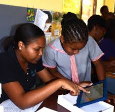 Students working together at a tablet